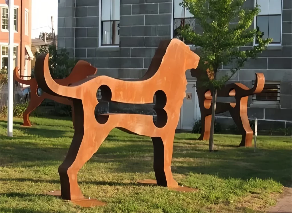 Corten steel dog sculptures in garden