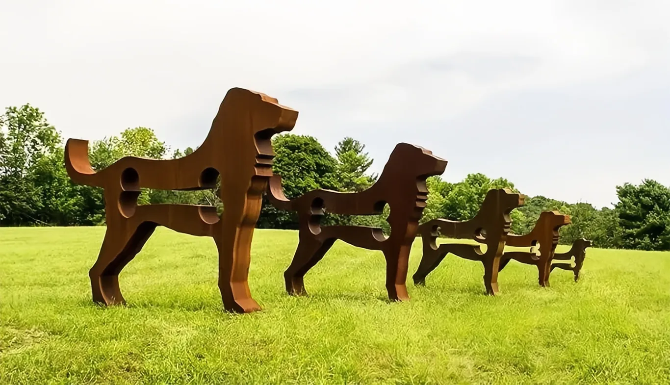 Corten steel dog sculptures in park